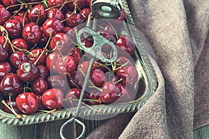 Vintage tray of cherries with stone remover