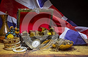 Vintage treasure box with British flag in background showing colonialism era gold hunt missions and wars