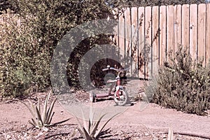 Vintage tricycle sitting in a yard
