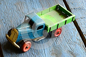 Vintage truck (lorry) toy on blue wooden background