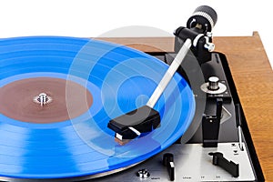 Vintage turntable with a blue vinyl isolated on white