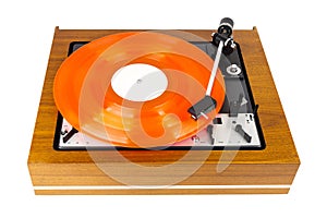 Vintage turntable with a red vinyl isolated on white