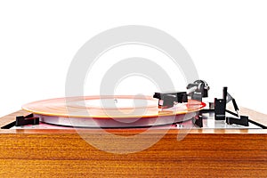 Vintage turntable with a red vinyl isolated on white