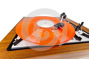 Vintage turntable with a red vinyl isolated on white