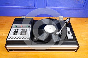 Vintage turntable vinyl record player with black vinyl