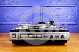 Vintage turntable vinyl record player with blue and orange vinyl