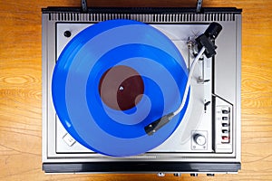 Vintage turntable vinyl record player with blue vinyl