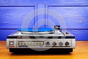 Vintage turntable vinyl record player with blue vinyl