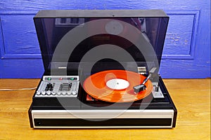 Vintage turntable vinyl record player with red vinyl