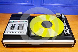Vintage turntable vinyl record player with yellow vinyl