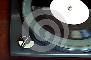Vintage turntable with vinyl record top view closeup