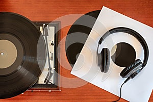 Vintage turntable with vinyls and headphones