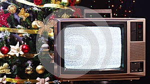 Vintage tv not working and Christmas tree with blinking lights behind