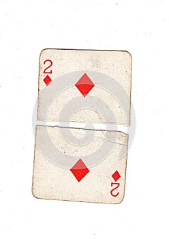 A vintage two of diamonds playing card torn in half.