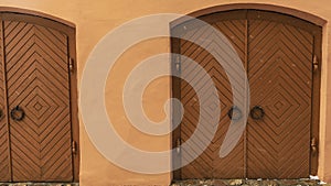 Vintage two wooden doors on the wall background. Old wall and worn doorways. Space for text