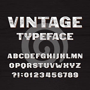 Vintage typeface. Retro alphabet font. Type letters and numbers on a rough wooden background.