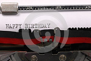 Vintage typewriter with black ink Happy Birthday message on paper