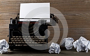 Vintage typewriter with empty, blank sheet of paper and crumbled