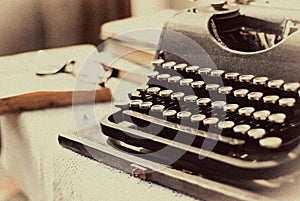 Vintage typewriter, old books on table