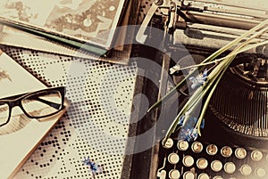 Vintage typewriter, old books on table