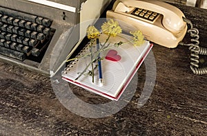 Vintage typewriter , old telephone , dry chrysanthemum flower and white paper note old wooden touch-up in still life concept