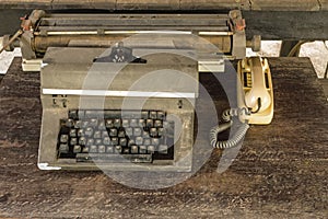 Vintage typewriter  and old telephone on old wooden touch-up in still life concept