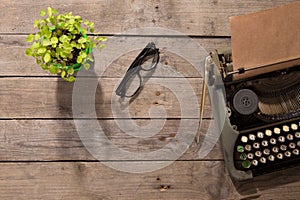 Vintage typewriter on the old wooden desk