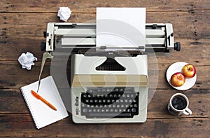 Vintage typewriter with a sheet of paper on an old desk