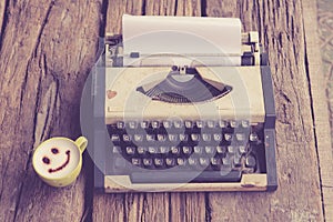 Vintage typewriter and telephone , notebook on the wood desk in