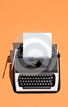 Vintage typewriter with a white blank page