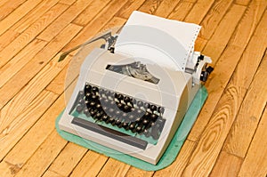 Vintage typewriter on a wooden floor