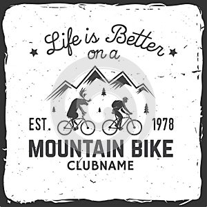 Vintage typography design with car and trailer, mountain bikes and mountain silhouette.