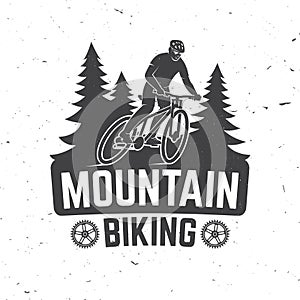 Vintage typography design with man riding bike and forest silhouette.