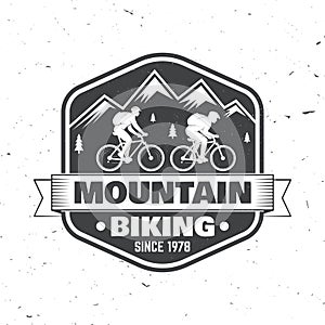 Vintage typography design with man riding bike and mountain silhouette.