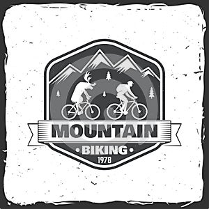 Vintage typography design with man riding bike and mountain silhouette.