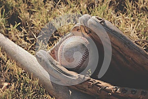 Vintage used baseball equipment in grass