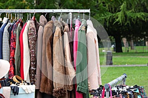 Vintage used and new clothes for sale in the stall stand at the flea market