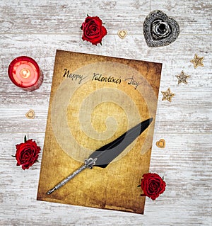 Vintage Valentine`s Day card with red candle and roses, ink and quill - top view