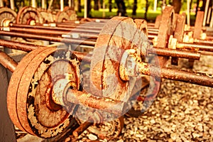 Vintage view of rusty old operational barbells mounted on the stand in public park