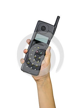 Vintage vintage phone with external antenna in child`s hand isolated on white background. Retro means of communication.