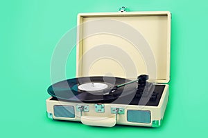 Vintage vinyl record player isolated on greenbackground