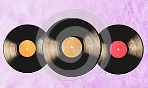 Vintage vinyl records on pink fur background