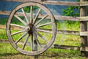 Vintage wagon wheel on old wooden fence