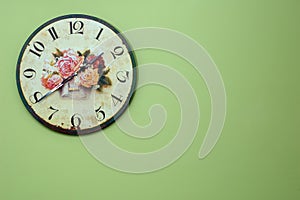 Vintage wall clock on the green wall