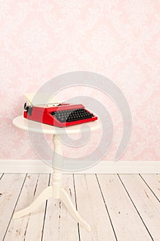 Vintage wall and wooden floor with old typewriter