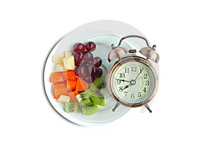 Vintage watch and healthy fruit platter, organic food and fruit and vegetable vitamins. The concept of nutrition, healthy food.