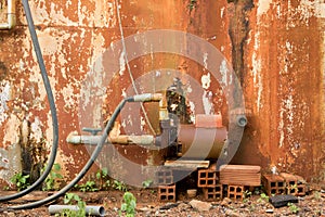 Vintage Water Turbine Generator on Old Wet Brick - Moldy Peeled