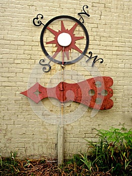 Vintage Weathervane on a Yellow Brick Wall