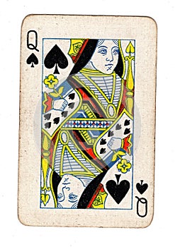 A vintage, well used queen of spades playing card.