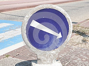 Vintage White arrow on blue traffic sign on street road